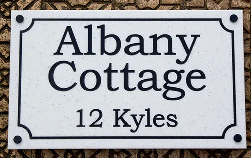 engraved corian sign with stand offs