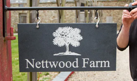 title here hanging engraved corian sign