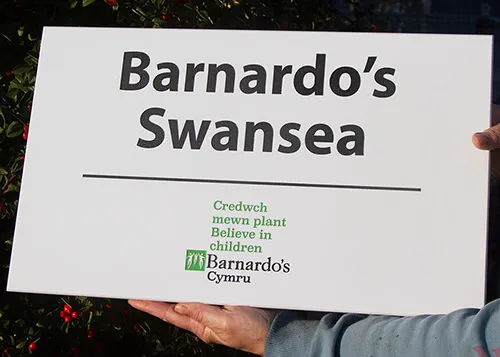 title here white engraved plaque with logo