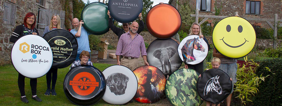The Sign Maker Team proudly showcases their range of wheel cover products. 