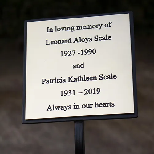 Brass memorial plaque with tree stake