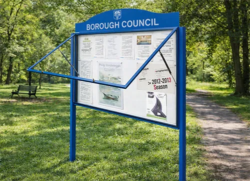 Lockable council notice board with lift-up glazed door