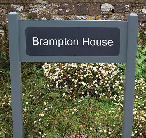 Painted entrance signs can be made of oak or sapele - both durable hardwoods. Handcrafted oak entrance sign with engraved corian plaque