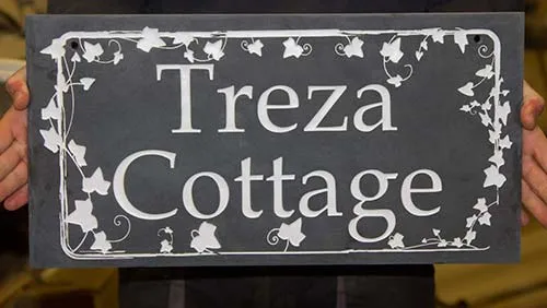 Slate house sign with a decorative boarder