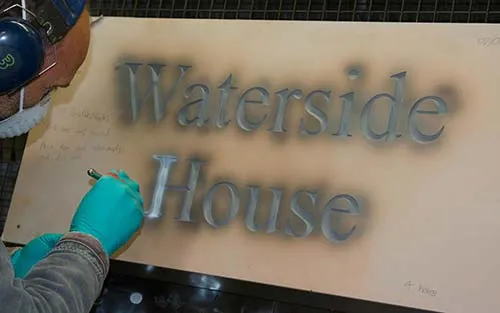 Painting letters in slate sign