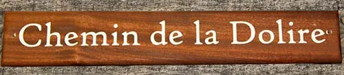 Sapele will have the most pronounced letters. Sapele Driftwood Sign