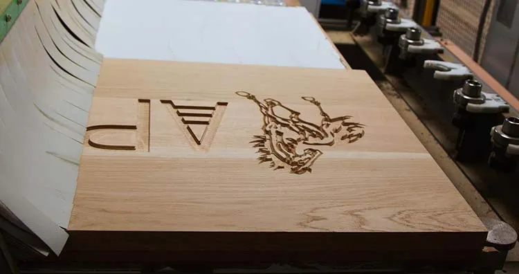 Large wooden sign being carved on CNC