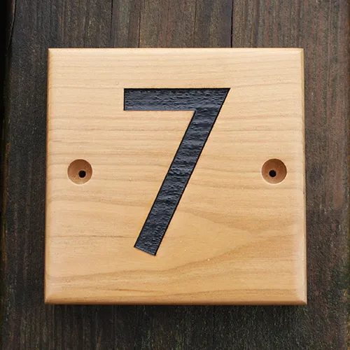 title here wooden house number sign