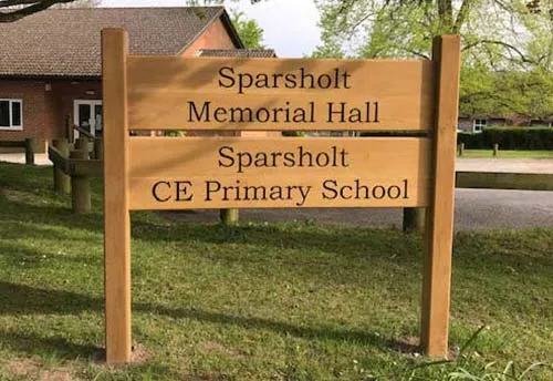 This is an oak sign morticed into oak posts. Wooden School Sign