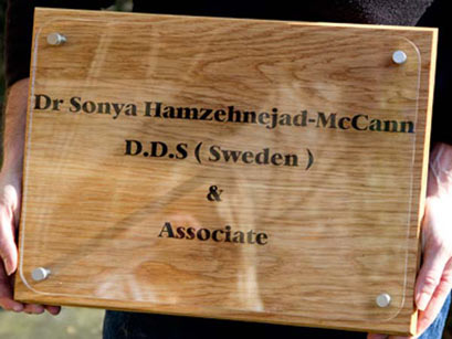 Clear acrylic mounted on wooden backing board.