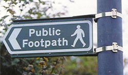 Directional sign with stainless steel straps.