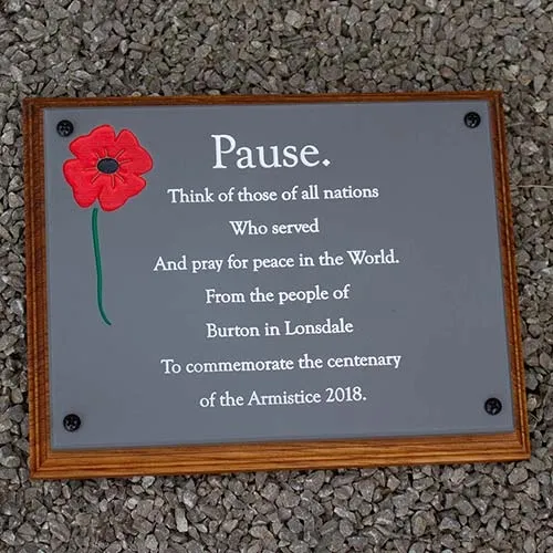 Engraved slate corian with engraved and painted poppy. Slate Corian on Backing Board.