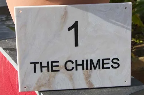 Engraved marble corian for a long lasting house sign. Engraved Corian House Sign