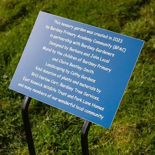 This plaque was fixed to a wrought Iron plate with tree stakes Blue/White Engraved Acrylic Plaque