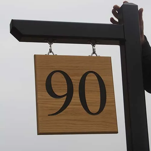 Very large hanging house number on painted hardwood post and arm. Painted Harrdwood Post & Arm