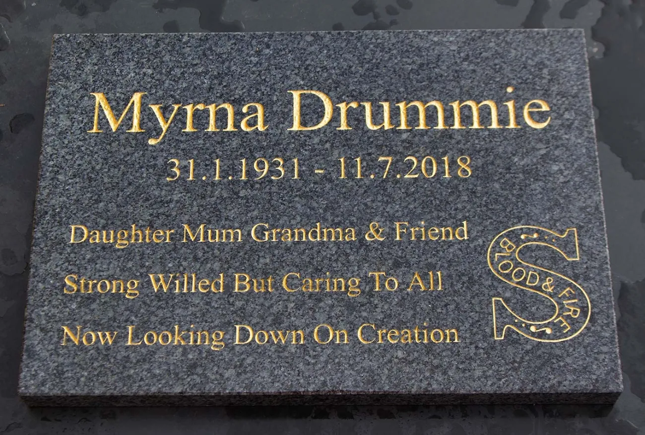 Dark grey granite with gold text. Grante Memorial Tablet