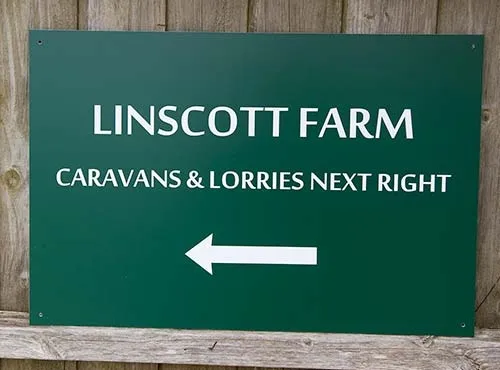 Green aluminium composite with white cut vinyl text Green Direction Sign