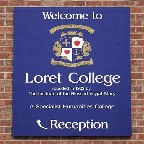 Blue aluminium tray sign with folded returns mounted to brick wall